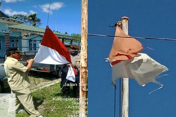 2 personil Polsek Raya Polres Simalungun BRIPKA Okto Freddy dan Brigadir Zulfan Effendi menurunkan kemudian mengganti dengan Bendera yang baru, Kamis (25/06/2020)